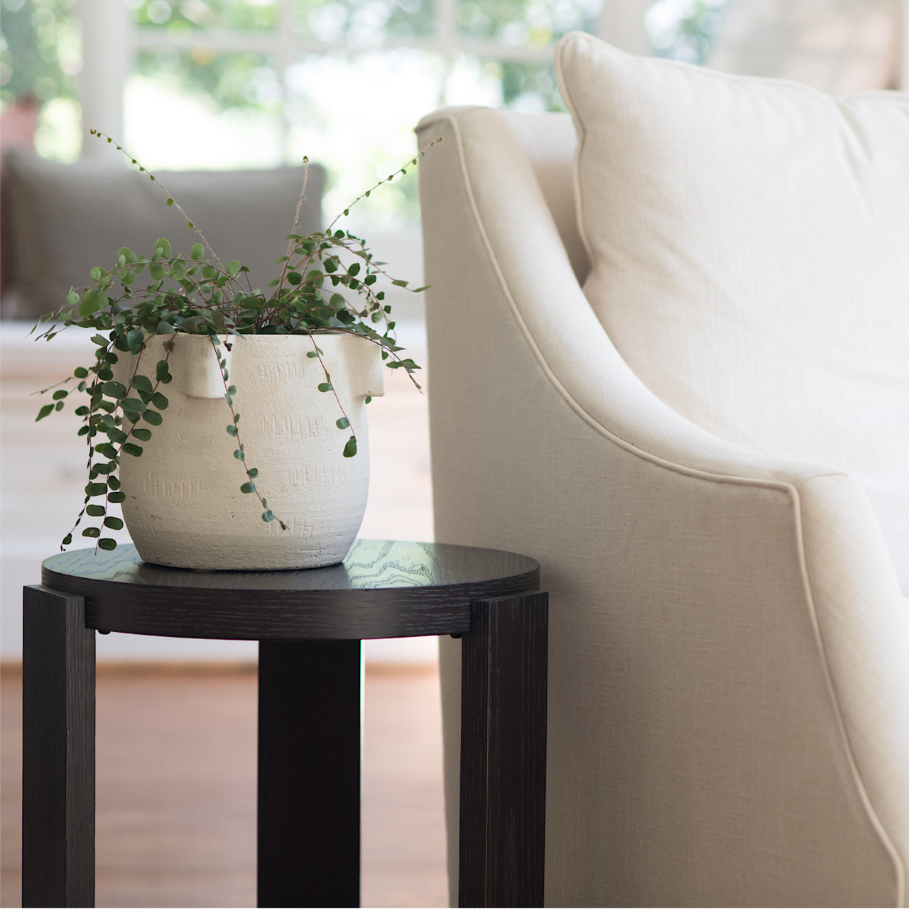 square image of the Rabbet 1005-10 drinks table next to a white upholstered chair